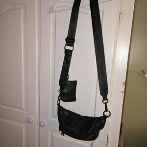 Black Steve Madden cross body/fanny pack. Two zipper closure.